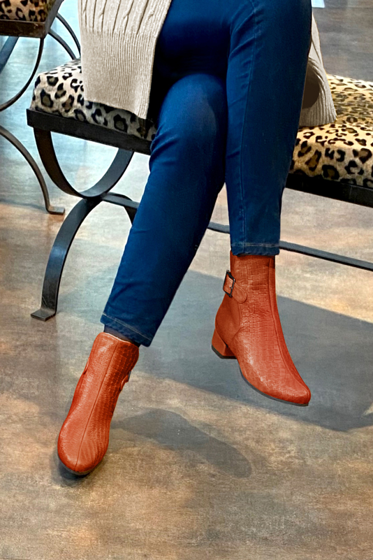 Terracotta orange women's ankle boots with buckles at the back. Round toe. Low block heels. Worn view - Florence KOOIJMAN